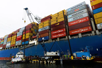 Cranes continue salvage work as wreckage of the Francis Scott Key Bridge rests on the container ship Dali, Wednesday, April 3, 2024, in Baltimore.