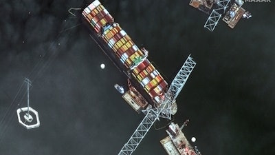 Satellite image showing the bow of the container ship Dali underneath sections of the fallen Francis Scott Key Bridge, Baltimore, April 8, 2024.