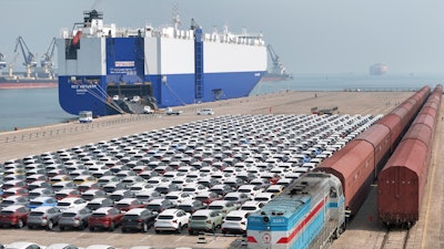 A freight train carrying cars to be exported arrives at a dock for ro-ro shipping in Yantai in eastern China's Shandong province Sunday, March 3, 2024.