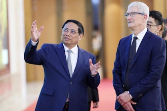 Vietnamese Prime Minister Pham Minh Chinh, left, speaks to Apple CEO Tim Cook, right, before their meeting in Hanoi, Vietnam on Tuesday, April 16, 2024.