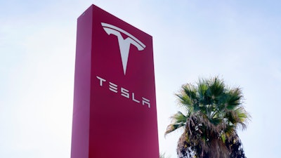 A Tesla sign is seen at a dealership, Dec. 3, 2023, in Buena Park, Calif.