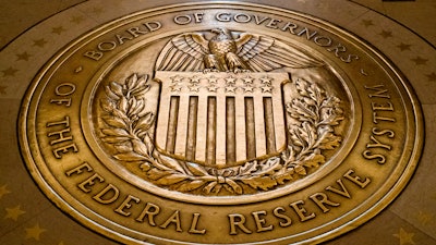 In this Feb. 5, 2018, file photo, the seal of the Board of Governors of the United States Federal Reserve System is displayed in the ground at the Marriner S. Eccles Federal Reserve Board Building in Washington.