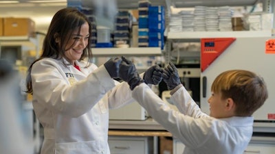 Researcher Diana Azzam and Logan Jenner, a participant in her clinical study, in the Azzam Lab at Florida International University.