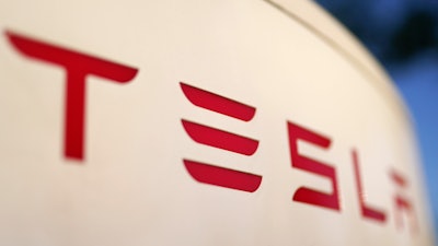 The logo for a Tesla Supercharger station is seen in Buford, Ga, April 22, 2021.