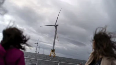 Passengers on a boat view America’s first offshore wind farm, owned by the Danish company Ørsted. Its five turbines generate power off Block Island, R.I.