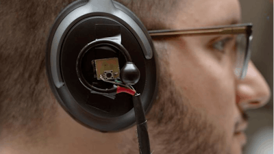 A University of Washington team has developed an artificial intelligence system that lets a user wearing headphones look at a person speaking for three to five seconds and then hear just the enrolled speaker’s voice in real time even as the listener moves around in noisy places and no longer faces the speaker. Pictured is a prototype of the headphone system: binaural microphones attached to off-the-shelf noise canceling headphones.