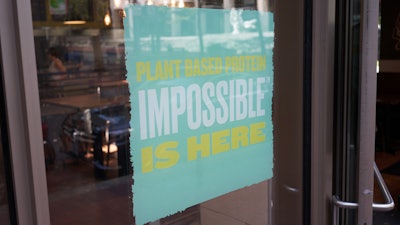 A QDOBA Mexican Eats restaurant in downtown Portland advertises the availability of Impossible brand plant-based protein in 2019.