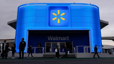 People walk by the Walmart booth during the CES tech show Tuesday, Jan. 9, 2024, in Las Vegas.