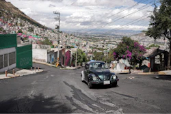 Janette Navarro drives her 1996 Volkswagen Beetle up a steep hill in the Cuautepec neighborhood of Mexico City, Friday, June 21, 2024.