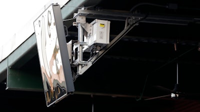 A radar device is seen on the roof behind home plate at PeoplesBank Park during the third inning of an Atlantic League All-Star minor league baseball game in York, Pa.