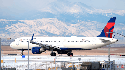 A Delta Airlines jetliner taxis on a runway at Denver International Airport.