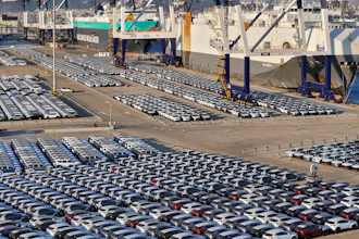 New cars for export wait for transportation on a vehicles carrier vessel at a dockyard in Yantai in east China's Shandong province.