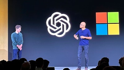 OpenAI CEO Sam Altman, left, appears onstage with Microsoft CEO Satya Nadella at OpenAI's first developer conference.