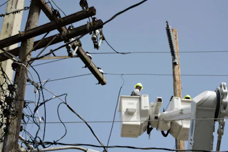 A brigade from the Electric Power Authority repairs distribution lines damaged by Hurricane Maria in the Cantera community of San Juan, Puerto Rico.