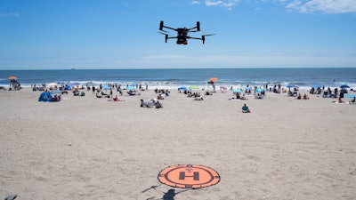 A drone lands for a battery swap at Rockaway Beach in New York.