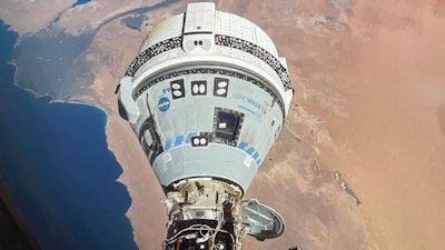This photo provided by NASA shows the Starliner spacecraft docked to the Harmony module of the International Space Station, orbiting 262 miles above Egypt's Mediterranean coast.