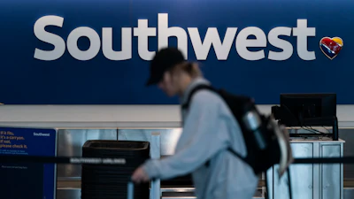 A traveler walks through the Southwest Airlines ticketing counter area at the Los Angeles International Airport.