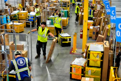 Amazon employees load packages at Amazon's DAX7 delivery station, South Gate, Calif., July 16, 2024.