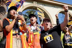 SAG-AFTRA captains Iris Liu, left, and Miki Yamashita, center, and SAG-AFTRA chief negotiator Duncan Crabtree-Ireland lead a cheer for striking actors outside Paramount Pictures studio, Nov. 3, 2023, in Los Angeles.