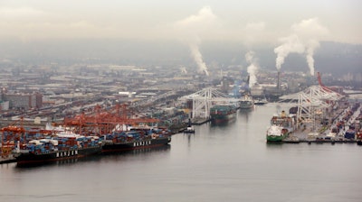 Container ships are docked at the Port of Seattle along the Duwamish River in Seattle.