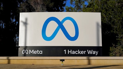 Meta's logo is seen on a sign at the company's headquarters in Menlo Park, Calif.