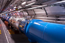 Particles rush through a long tunnel in the Large Hadron Collider.