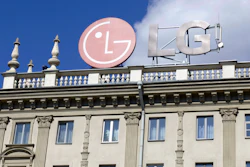 The emblem of the corporation LG on the roof of a historic building.
