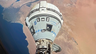 This photo provided by NASA shows the Starliner spacecraft docked to the Harmony module of the International Space Station, orbiting 262 miles above Egypt's Mediterranean coast.