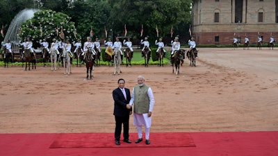 Indian Prime Minister Narendra Modi, right, receives his Vietnamese counterpart Pham Minh Chinh, during a ceremonial reception at the Rashtrapati Bhavan in New Delhi, India.