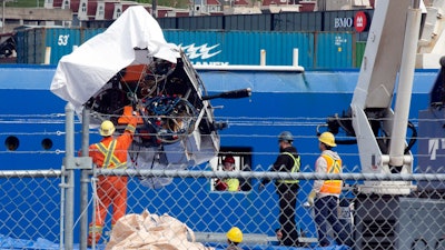 Debris from the Titan submersible, recovered from the ocean floor near the wreck of the Titanic, is unloaded from the ship Horizon Arctic at the Canadian Coast Guard pier in St. John's, Newfoundland.