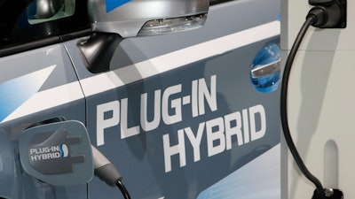 The plug to charge the batteries is plugged-in in a Toyota Prius Plug-In Hybrid on the first press day of the Frankfurt Auto Show in Frankfurt, Germany.