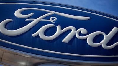 A Ford company logo on a sign at a Ford dealership.