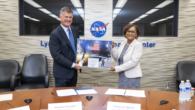 Giovanni Cristofoli, SVP of bp Solutions, and Vanessa Wyche, Director of NASA's Johnson Space Center, sign a Space Act Agreement between bp and NASA.