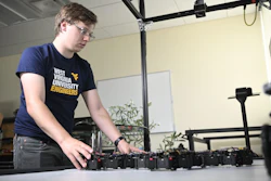 In Yu Gu’s Interactive Robotics Laboratory at WVU, doctoral student Trevor Smith observes Loopy, a multicellular robot that is learning to respond organically and autonomously to its environment.