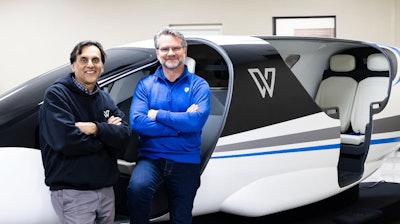 Whisper Head of Flight Sciences Vineet Ahuja, left, and Whisper Co-founder and CEO Mark Moore are standing in front of the Whisper Jet cabin prototype.