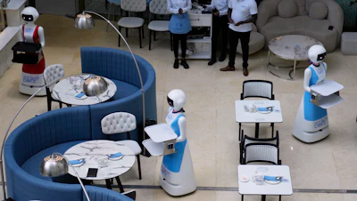 Robotic waiters serve customers at a Robot Cafe in Nairobi, Kenya, Aug. 29, 2024.