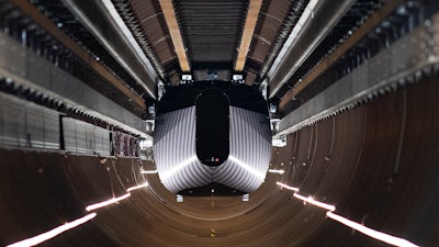 A test vehicle levitated by magnetic fields zips through a depressurized tube in a testing ground for a high-speed transit system during a press tour of a European test center for hyperloop transportation technology in Veendam, northern Netherlands.