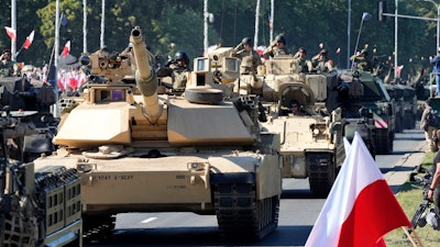 U.S.-made Abrams tanks purchased by Poland take part in a military parade in Warsaw, Poland.
