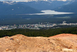 Piles of ore discarded decades ago are seen with the town of Leadville, Colo., in the background