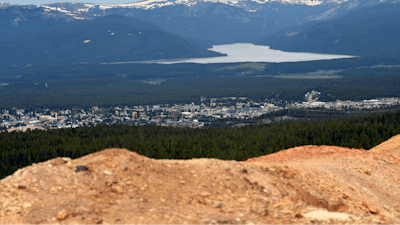 Piles of ore discarded decades ago are seen with the town of Leadville, Colo., in the background