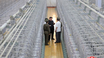 This undated photo provided on Friday, Sept. 13, 2024, by the North Korean government shows its leader Kim Jong Un, center, on an inspecting visit at what they say is an institute of nuclear weapons and a facility for nuclear materials at an undisclosed location in North Korea.