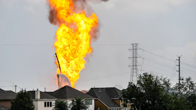 A firefighter directs a line of water around a fire on a pipeline carrying liquified natural gas near Spencer Highway and Summerton on Monday, Sept. 16, 2024, in La Porte, Texas.