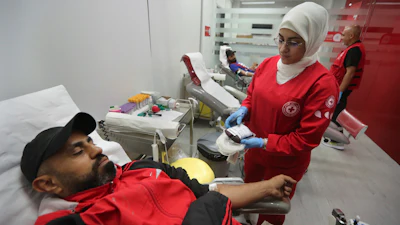 People donate blood for those who were injured by their exploded handheld pagers, at a Red Cross center, in the southern port city of Sidon, Lebanon, Tuesday, Sept. 17, 2024.