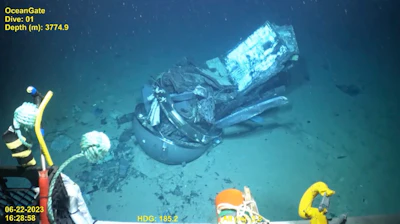 This June 2023 United States Coast Guard still frame from video provided by Pelagic Research Services, shows remains of the Titan submersible, center, on the floor of the Atlantic Ocean.