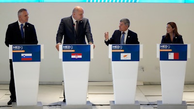 Cypriot Minister of Energy George Papanastasiou, center right, talks with his counterparts of Malta Miriam Dalli, right, Slovenia Bojan Kumer, left, and Croatia Economy Minister Ante Susnjar, center left, during a press conference after the MED9 Energy Ministerial Meeting in southern coastal city of Larnaca, Cyprus.