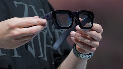 Mark Zuckerberg holds a pair of Orion AR glasses during the Meta Connect conference Wednesday, Sept. 25, 2024, in Menlo Park, Calif.
