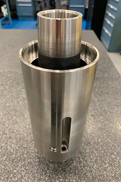 A finished oil and gas component, featuring a specialized coating on the interior diameter to reduce wear and extend operational life.