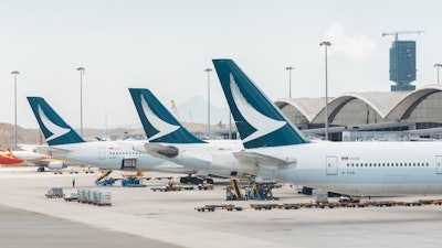 Cathay Pacific airline airplanes grounded at Hong Kong International airport.