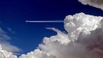 Contrail stream following a distant passenger jet.