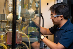 Working at Richland, Wash., Daniel Santosa, a Washington State University doctoral student and scientist at Pacific Northwest National Laboratory, tests a WSU-developed continuous process that turns lignin, a polymer found in plants, into jet fuel.